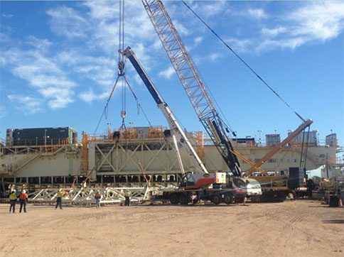 An image of a crane lifting heavy quipment materials- MM & IM Local Infrastructure  