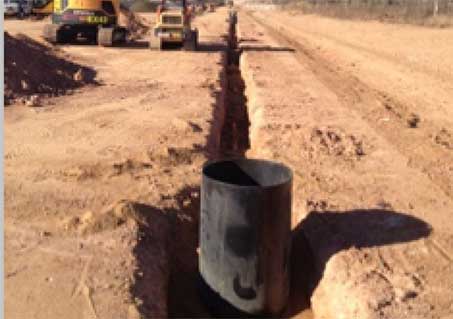 Pipe installation in a trench beside the road - MM & IM Local Infrastructure