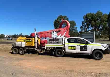 Pick-up truck pulling a heavy equipment vehicle - MM & IM Local Infrastructure Mangement Specialist